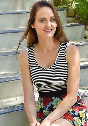 Brunette in a striped get-up flashes her cleavage while out in public